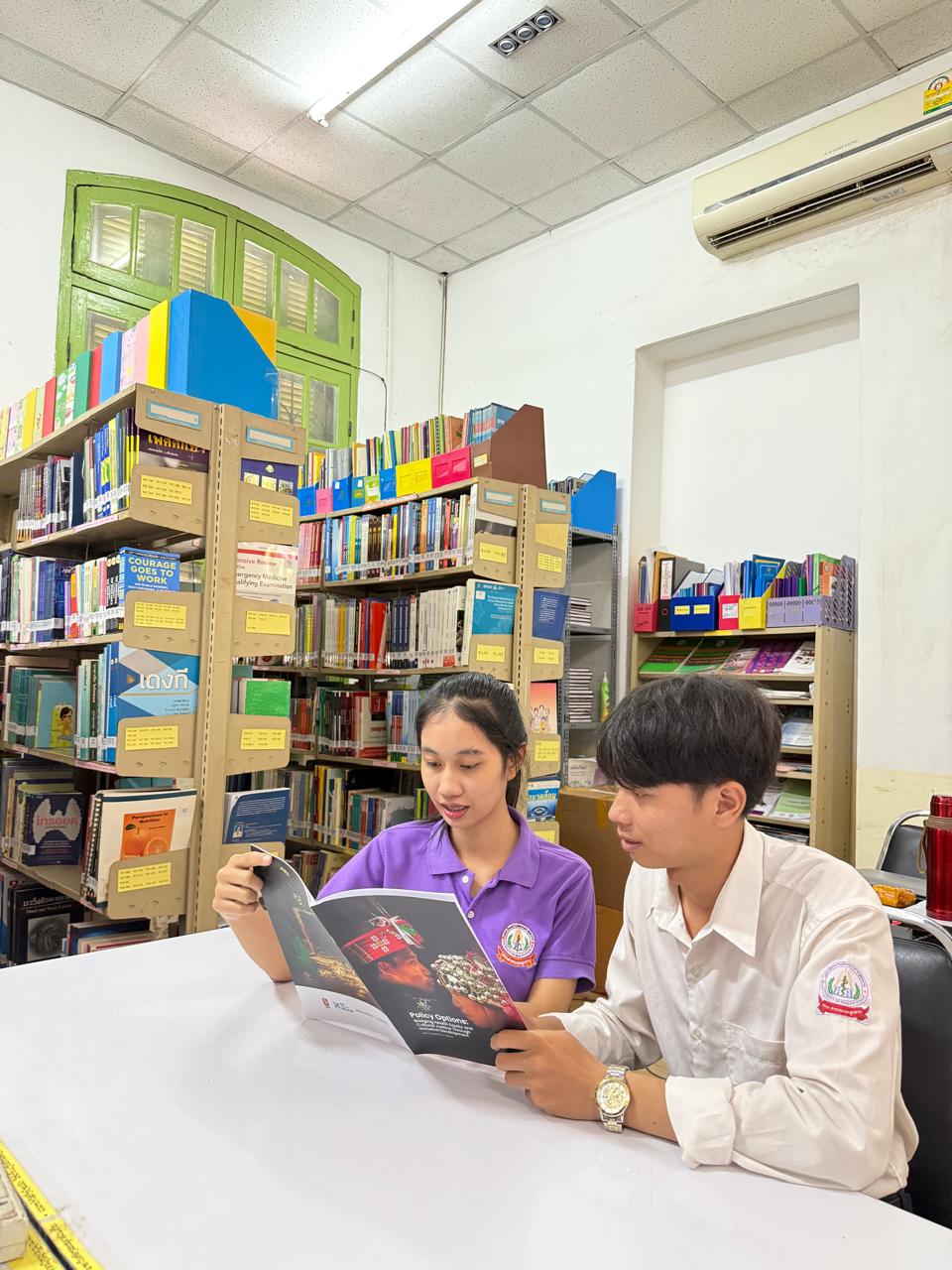 Students from the University of Health Sciences School of Public Health of Laos reading the book Students from the University of Health Sciences School of Public Health of Laos reading the book